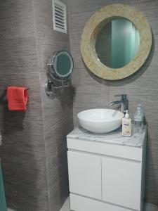 a bathroom with a sink and a mirror on the wall at La mejor ubicación Condomar 133 in Puerto Vallarta +75 photos