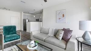 a living room with a couch and a table at Landing Beautiful 1BD in North Fort Worth in Fort Worth