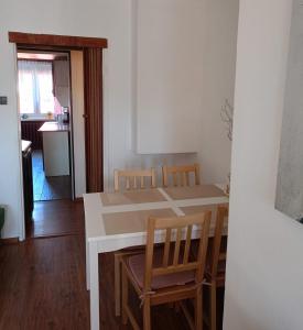 a kitchen with a table and chairs in a room at Hel - Apartament in Hel