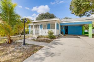 a house with a blue door and a street light at Walk to Shops and Dining Downtown Stuart Home! in Stuart