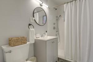 a white bathroom with a sink and a mirror at Walk to Shops and Dining Downtown Stuart Home! in Stuart +16 photos