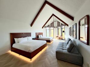 a bedroom with a bed and a couch in a room at Hotel Lac Carling Spa Golf in Harrington +63 photos