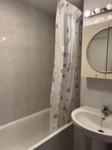 a bathroom with a sink and a shower curtain at Riviera patio in Miami Platja