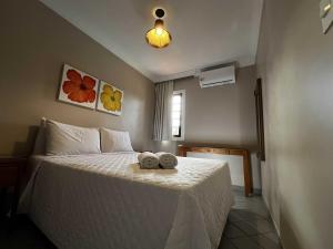 En eller flere senge i et værelse på Pousada Porto Mar