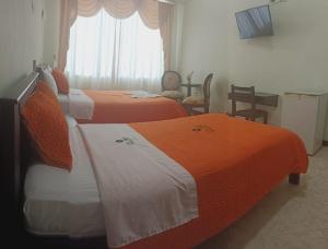 En eller flere senge i et værelse på Hotel Oro Negro