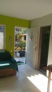 a living room with a couch and a door at Jardim Caribenho in Arraial do Cabo +38 photos