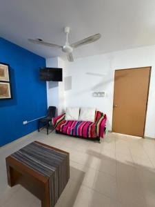 a living room with a couch and a table at Hostal Casa Bohemia in Mérida +28 photos