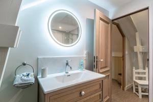 a bathroom with a sink and a mirror at La Grive - Petit nid douillet proche de la plage in Étretat +12 photos
