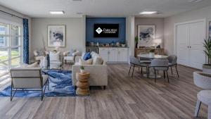 a living room with couches and a dining room at Landing Apartments - The Carlisle at Dunedin in Dunedin