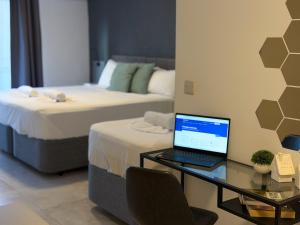 Giường trong phòng chung tại D' Suites Holiday Apartments