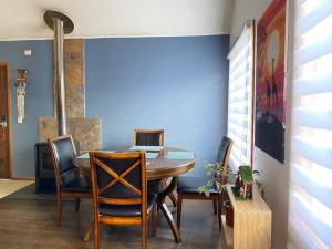 a dining room with a table with a laptop on it at Casa Lepeley Colimilla in Frutillar