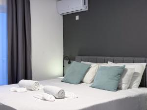 a bedroom with a bed with towels on it at D' Suites Holiday Apartments in Il-Gżira