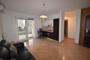 a large living room with a couch and a kitchen at Nenni House in Sassari +14 photos