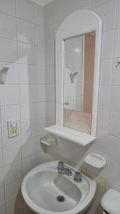 ein weißes Badezimmer mit Waschbecken und Spiegel in der Unterkunft Valle del Río Chico in Gobernador Gregores