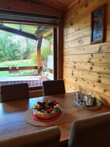 a wooden table with a plate of food on it at Brvnare Duguljac Fruška Gora in Bukovac +50 photos