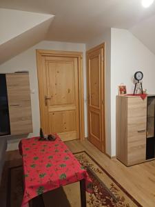a room with a table with a red cloth on it at Ubytovanie Málika in Čierny Blh