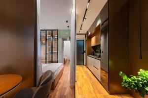 a room with a bed and a table and a kitchen at PR Luxury Apartment in Parga