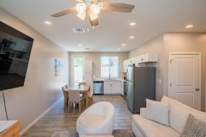a kitchen and living room with a couch and a table at Serene 2BR Home with Premium Beds in Glendale