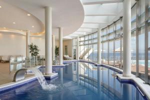a pool with a waterfall in a hotel lobby at Sheraton Miramar Hotel & Convention Center in Viña del Mar