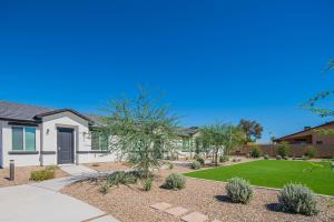 a house with a garden and a lawn at Serene 2BR Home with Premium Beds in Glendale