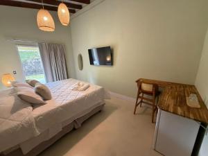 Et tv og/eller underholdning på Pousada Casa Canoa - Pé na Areia & Alta Gastronomia