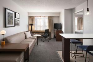 a living room with a couch and a table and a desk at Residence Inn by Marriott Fort Collins in Fort Collins +20 photos
