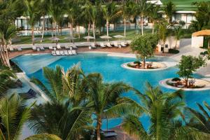 eine Aussicht über den Pool des Resorts mit Palmen in der Unterkunft The St. Regis Cap Cana Resort in Punta Cana