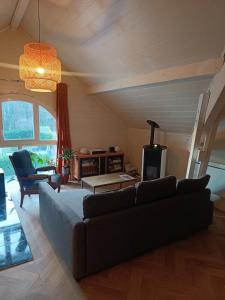 ein Wohnzimmer mit Sofa und Tisch in der Unterkunft Apartment in Villa with garden in Vérel-Pragondran