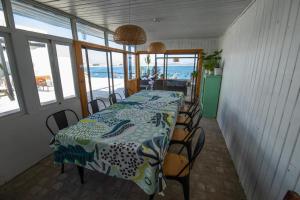 a dining room with a table and chairs and the ocean at CasaMar Tongoy in Tongoy