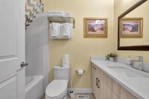 a bathroom with a white toilet and a sink at banff woods lodge in Canmore +46 photos