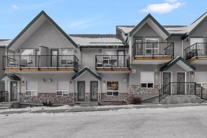 a large house with balconies on the side of it at banff woods lodge in Canmore