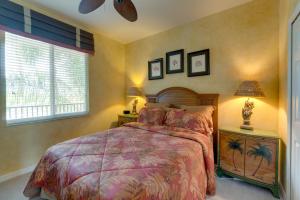 a bedroom with a large bed and two windows at River Strand Country Club Condo with Pool Access! in Bradenton +24 photos