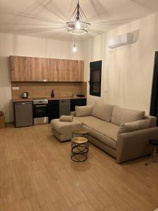 a living room with a couch and a kitchen at Holiday home Lavande in Tivat