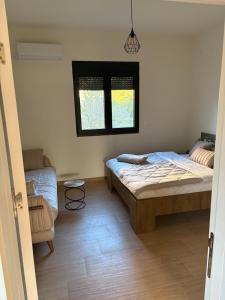 a bedroom with two beds and a window at Holiday home Lavande in Tivat