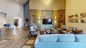 a living room with couches and chairs and a television at Landing Stunning 2BD in Corinth in Denton