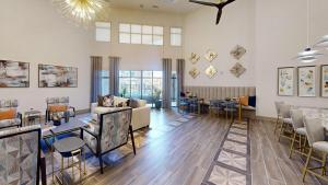 a living room with a couch and tables and chairs at Landing Stunning 2BD in Corinth in Denton