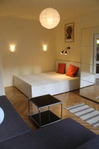 a bedroom with a bed with red pillows and a table at City Centre Apartment in Budapest