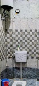 a bathroom with a toilet and a sink at Siddhi's Inn in Prayagraj