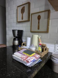 eine Küchentheke mit einem Tisch, auf dem Handtücher und ein Mixer stehen in der Unterkunft Maravilhosa casa linear 5 suítes em Angra in Angra dos Reis