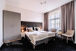 a bedroom with a large bed and a window at SERENITY Aparthotels - Old Town Poznan by Friendly Apartments in Poznań