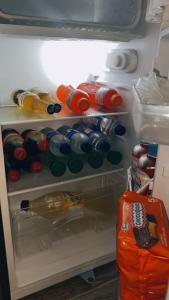 an open refrigerator filled with lots of soda bottles at Finca Hotel Yamboró in Pitalito