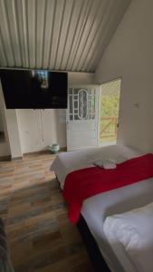 a bedroom with a bed and a flat screen tv at Finca Hotel Yamboró in Pitalito +227 photos