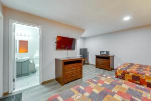 a room with a bedroom with a bed and a bathroom at Ski, Explore, Bring Pets! Studio 5 Mi to Pine Knob in City in the Village of Clarkson