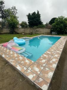 a swimming pool with a raft and a float in a yard at 33 Boeren in Vryheid