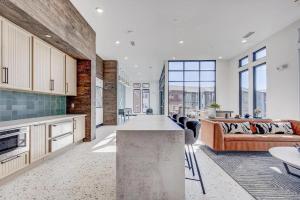 an open kitchen and living room with a couch at Landing Stylish 2BD Gym Pool in Colorado Springs