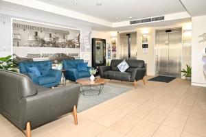 a living room with two couches and a table at Ocean Views Retreat, Caloundra in Caloundra