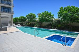 a swimming pool in the middle of a building at Ocean Views Retreat, Caloundra in Caloundra