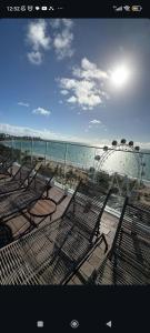 a group of chairs and a roller coaster at the beach at Pajuçara Front Beach in Maceió +38 photos