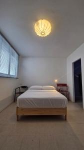 a bedroom with a bed with a light on the ceiling at Loft 201 H54 Waiwa host in Bucaramanga +5 photos