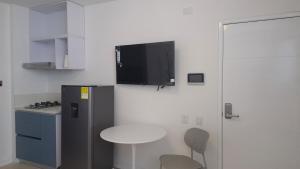 a kitchen with a small table and a refrigerator at Loft 201 H54 Waiwa host in Bucaramanga